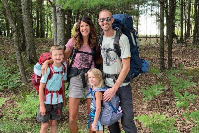 Family Gathered With Backpacks.
