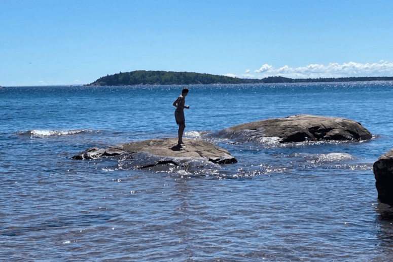 A Boy On A Rock In Lake Superior.