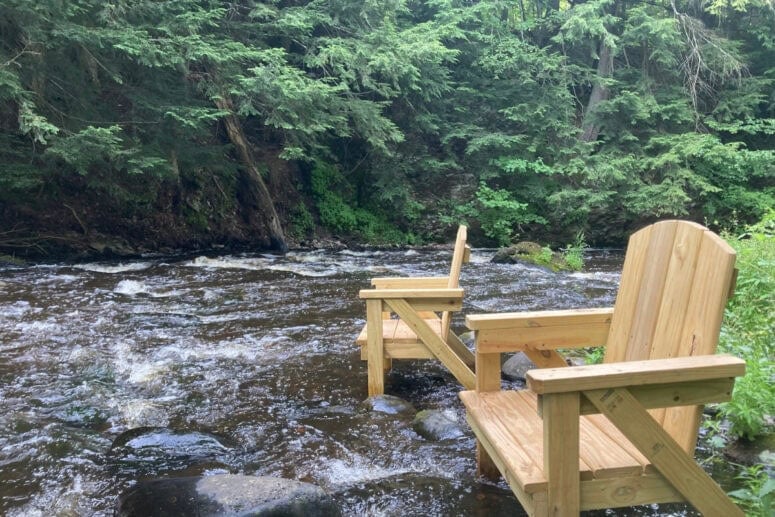 Chairs Sit In A Rushing River.
